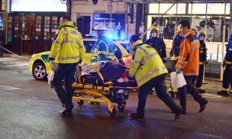 Paramedics attend to an injured person at the scene.