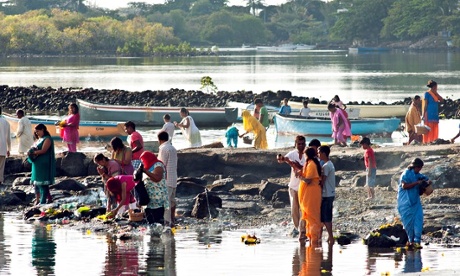 Women on a riverbank in Mauritius