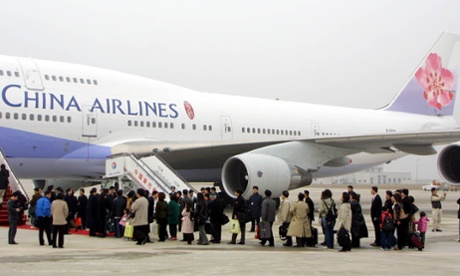 Passengers board a flight at Shanghai Pudong airport.