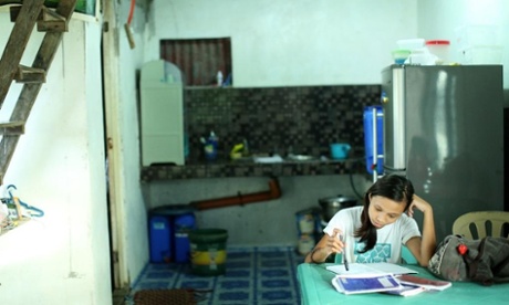 Young girl studying at home in the Philippines.