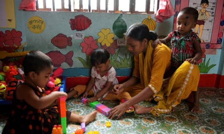 Woman caretaker playing with children in daycare centre in Dhaka, Bangladesh.