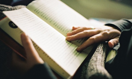 A book with hands over the pages