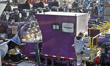 A machine mixes sand, water and chemicals before it is pumped underground during a fracking operation at a drilling site.