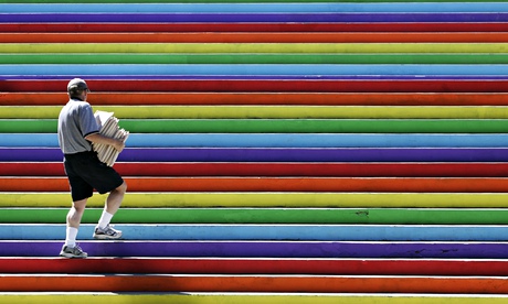 Man walks up rainbow stairs