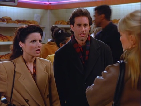 Elaine in a camel trenchcoat.