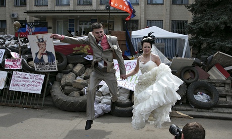 A bride and groom in front of a regional government building seized by pro-Russians in Kramatorsk