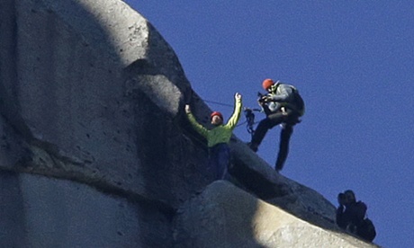 Tommy Caldwell, top, raises his arms after reaching the summit of El Capitan.