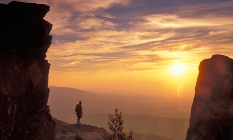 A hiker at sunset on Humpback Rocks on the Appalachian Trail, in Virginia, US.