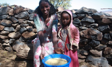 Fana Fesseha and her three-year-old daughter with bucket of honey
