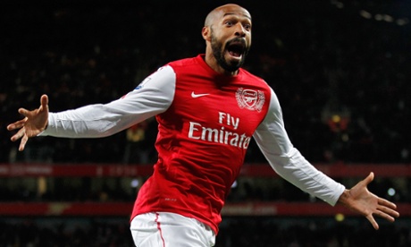 Thierry Henry in an Arsenal shirt looks joyous with arms outstretched after scoring a goal