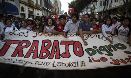 Students attend an anti-government protest on 15 January, 2015 in Lima, Peru. Thousands marched through Lima to protest against the youth labour law that eliminates rights for workers aged 18-24.