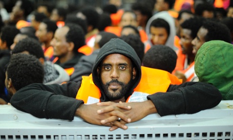 Migrants from sub-Saharan Africa crowd on to an Italian ship after being rescued last May in the Mediterranean. The number of migrants arriving in Italy quadrupled in 2014