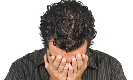 25 years old Middle Eastern man crying with head in hands