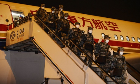 A medical team sent by China to Liberia to assist in the fight against Ebola arrives back at Chongqing Jiangbei International airport.