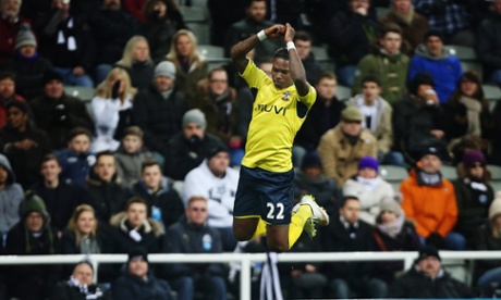 Elia celebrates again after holding off Janmaat to score.