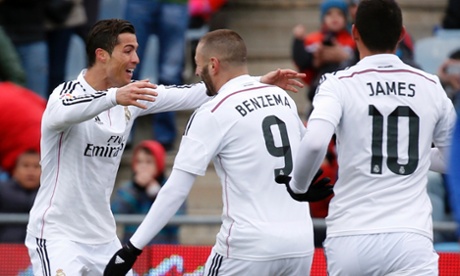 Real Madrid's Cristiano Ronaldo celebrates with teammates Karim Benzema and James Rodriguez after scoring against Getafe.