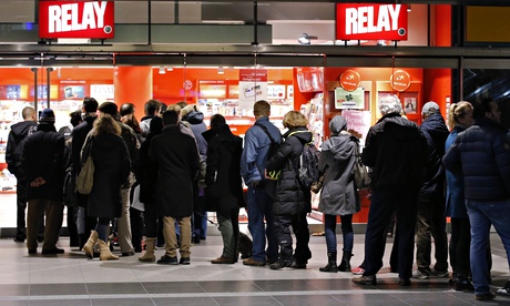 Customers queue to buy the first edition of Charlie Hebdo since the terror attack on the magazine