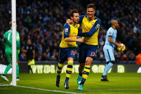 Santi Cazorla celebrates his goal from a penalty with teammate Olivier Giroud
