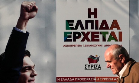 A man walks past a banner with an image of opposition leader and head of radical leftist Syriza party Alexis Tsipras at the party's pre-election kiosk in Athens.