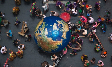 Activists push an inflatable globe during a 