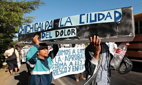 People carry a mock coffin 