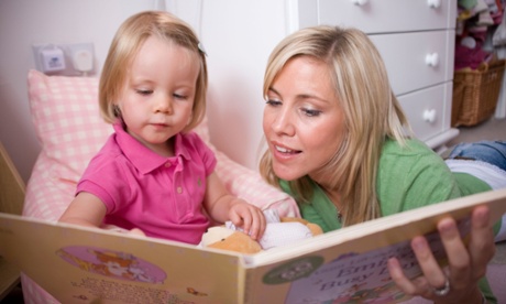 Mother reading a book with their child