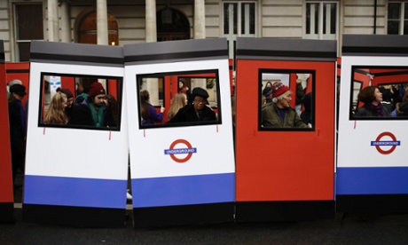 People carry parts of a wooden Underground Tube train for London New Year's Day Parade.