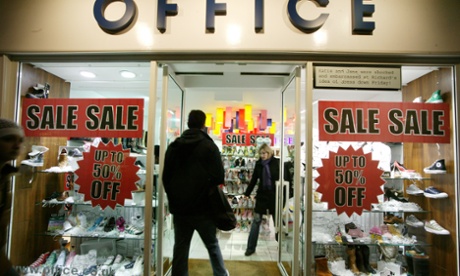 Winter sale signs in an Office shoe shop window in London. Many stores already have reductions despite this being a busy week for Christmas shopping