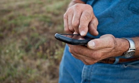 Close up of older man using cell phone