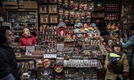 Chinese vendors wait for customers at a market in central Beijing