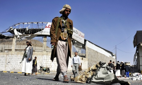 Houthi fighters stand on a street near the presidential palace in Sana'a.