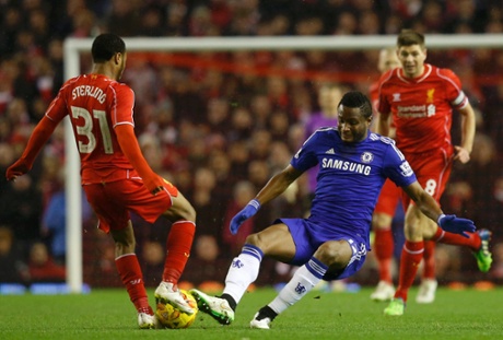 John Obi Mikel slides in on Raheem Sterling.