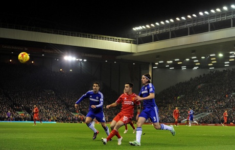 Philippe Coutinho crosses before Cesc Fabregas can get to him..