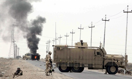 British soldiers at the scene where a roadside bomb exploded next to a British military armoured vehicle east of Basra.