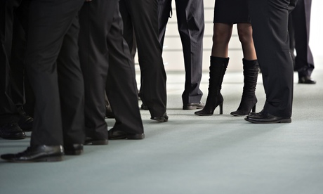 Business women's legs among men in suits