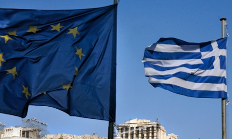Greek and EU flags fly in front of the Parthenon in Athens.
