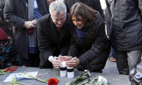 Mayor of New York Bill de Blasio and Mayor of Paris Anne Hidalgo (R) lay a candle next to the offices of French satirical weekly Charlie Hebdo on January 20, 2015, in Paris, France.