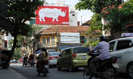 A giant poster, encouraging passerbys to stop using rhino horn, is seen on a street in Hanoi September 22, 2014.