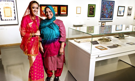 Tahnia Ahmed, left, models the wedding sari of her mother Hasna Hena at the Jewish Museum