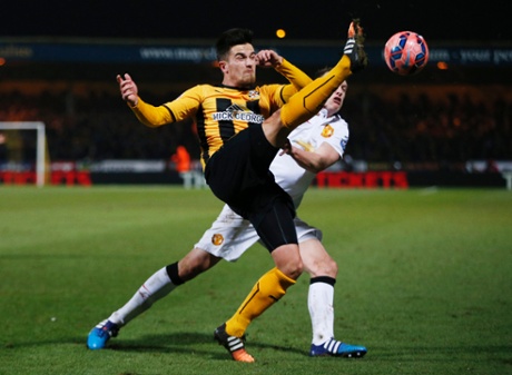 Cambridge's Ryan Donaldson battles with Phil Jones.
