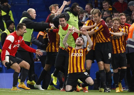 Bradford City midfielder Mark Yeates, centre, drops to his knees as he celebrates scoring his team's fourth goal.
