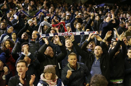 Some of the 6,000 Bolton fans, who are a happy bunch after leaving Anfield with a draw following a good performance by their team.