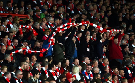 Bristol City fans tie their scarves together as they show their support.