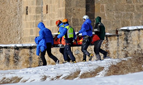 French rescuers carry one of the victims of an avalance in the Queyras range