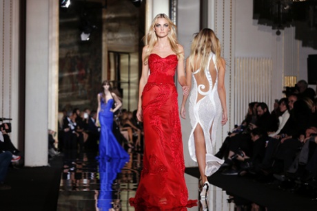 Models present creations by Italian designer Donatella Versace.