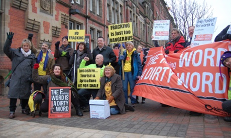 Demonstrators holding placards and protesting outside the offices of Lancashire County Council, where a decision is being made about the possibility of fracking.