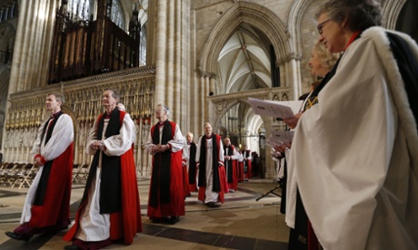 Members of the clergy process into York minster for the consecration.