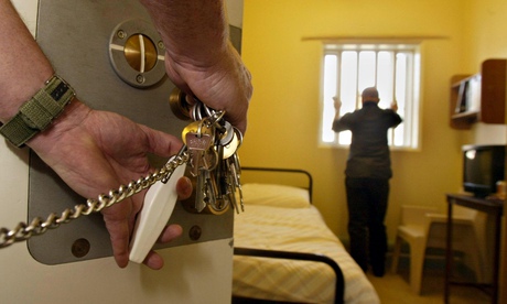 Prison officer unlocking a cell
