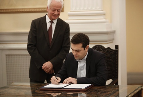 Greek radical leftist party SYRIZA leader Alexis Tsipras (R) signs protocols after his swearing-in as Prime Minister by the President of Republic Karolos Papoulias (unseen) at the Presidential Palace in Athens, Greece, 26 January 2015.