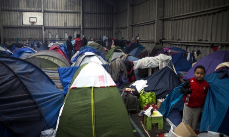 Migrants, mainly from Eritrea, take shelter in an abandoned warehouse